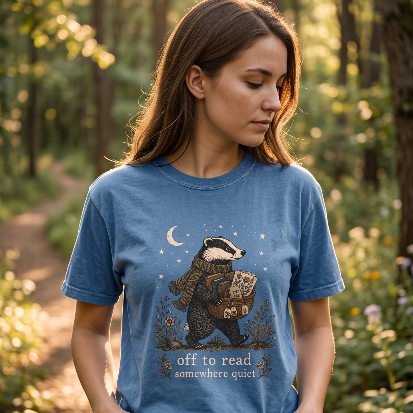 Off to Read Somewhere Quiet reading T-shirt featuring a woodland badger with books, tea, flowers, moon and stars
