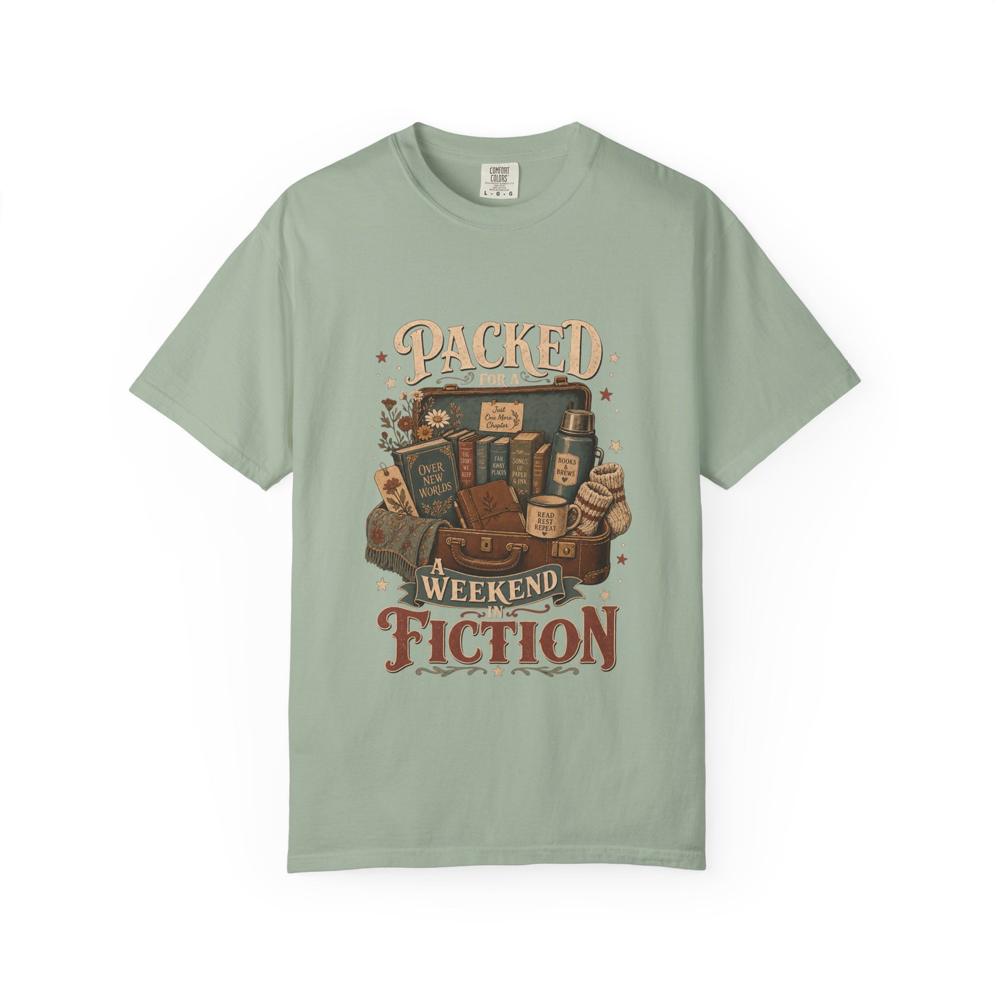 Packed for a Weekend in Fiction Book Lover Shirt printed on a Comfort Colors 1717 Bay garment-dyed T-shirt front view featuring a vintage suitcase filled with books, a cosy blanket, journal and reading essentials.