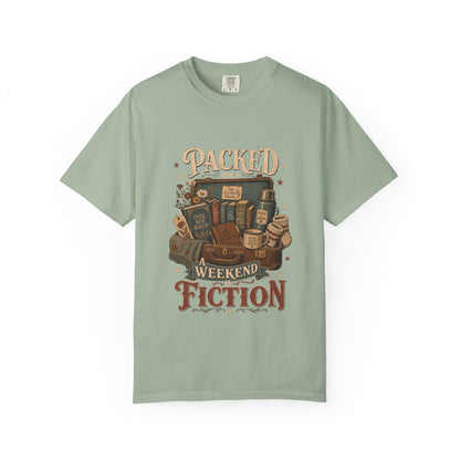 Packed for a Weekend in Fiction Book Lover Shirt printed on a Comfort Colors 1717 Bay garment-dyed T-shirt front view featuring a vintage suitcase filled with books, a cosy blanket, journal and reading essentials.