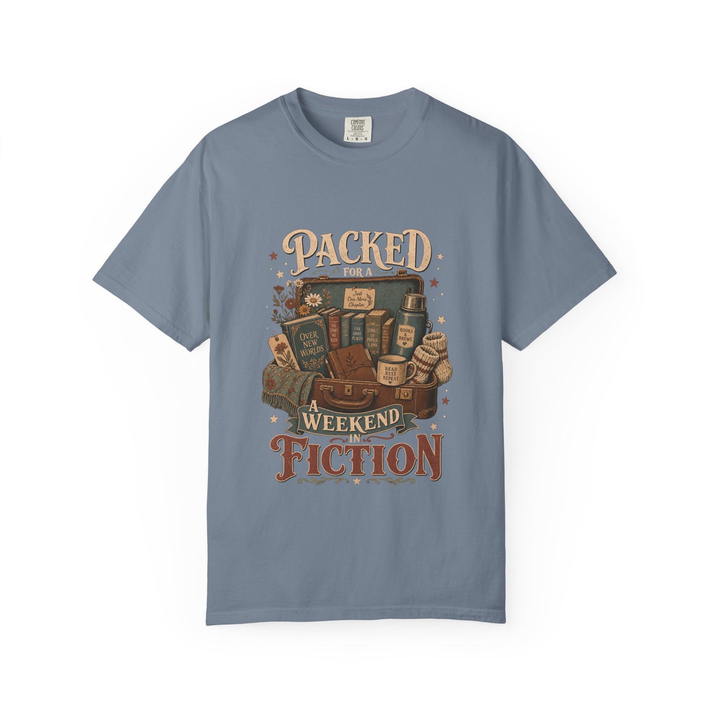 Packed for a Weekend in Fiction reading T-shirt in Blue Jean featuring a vintage suitcase packed with books, a mug, thermos and cozy socks