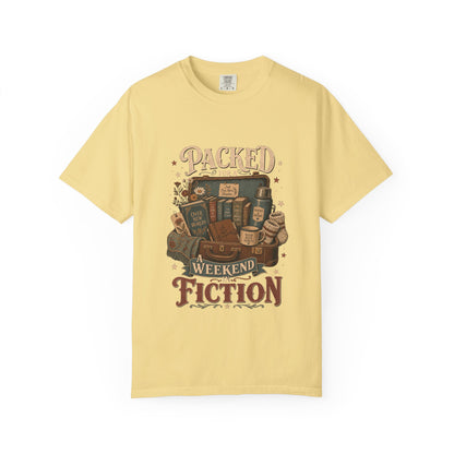 Packed for a Weekend in Fiction reading T-shirt in Butter featuring a vintage suitcase packed with books, a mug, thermos and cozy socks