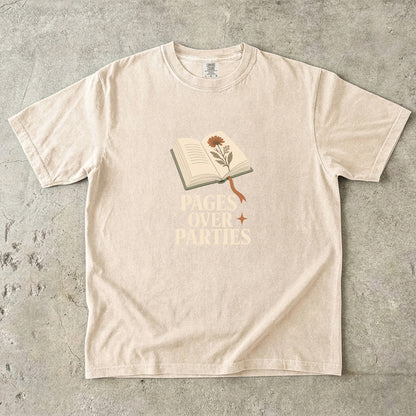 Pages Over Parties introvert reader shirt in Ivory featuring an open book, flower and bold book lover statement.
