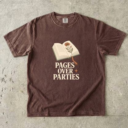 Pages Over Parties introvert reader shirt in Espresso with an open book, botanical illustration and cream lettering.