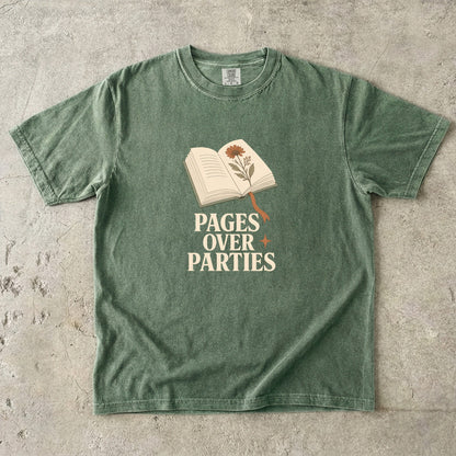 Pages Over Parties introvert reader shirt in Moss featuring an open book, pressed flower and bold cream typography.