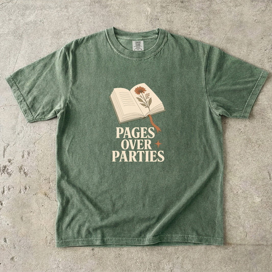 Pages Over Parties introvert reader shirt in Moss featuring an open book, pressed flower and bold cream typography.