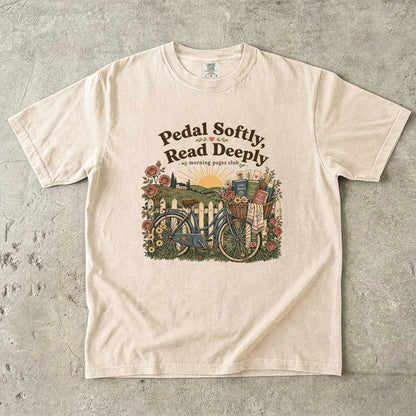 Pedal Softly, Read Deeply book lover T-shirt with vintage bicycle, books and flowers on Ivory.