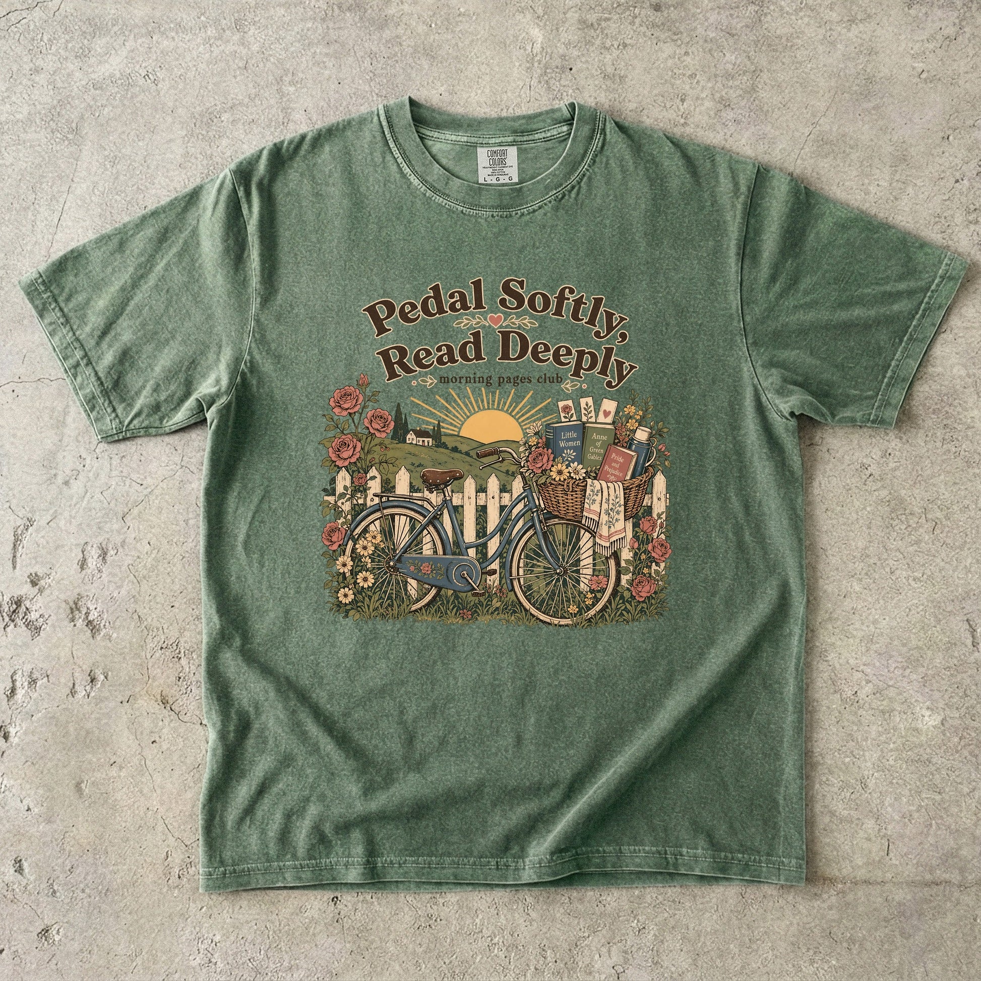Pedal Softly, Read Deeply book lover T-shirt with vintage bicycle, books and flowers on Moss.