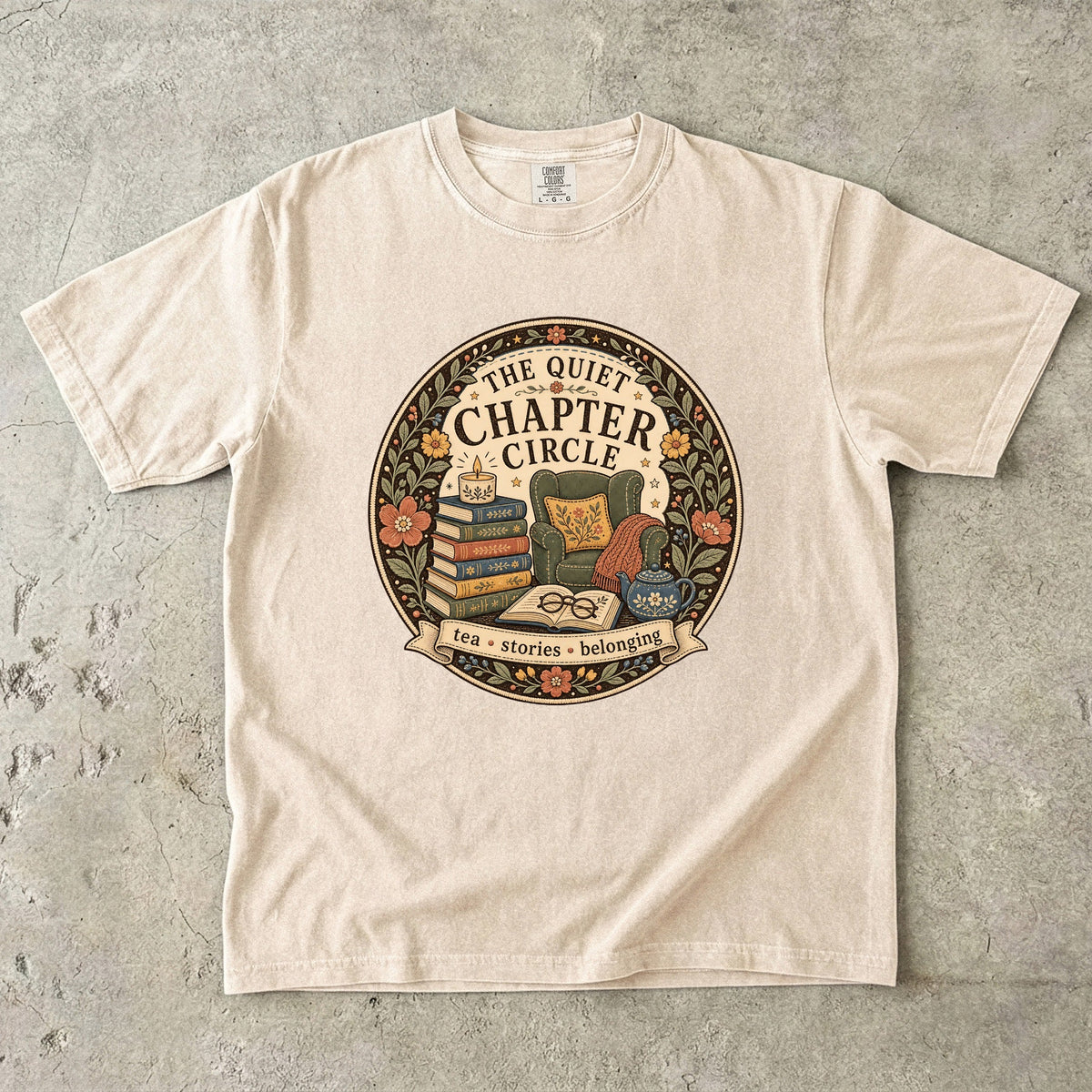 Quiet Chapter Circle book club T-shirt with armchair, stacked books, teapot and floral reading design on Ivory.