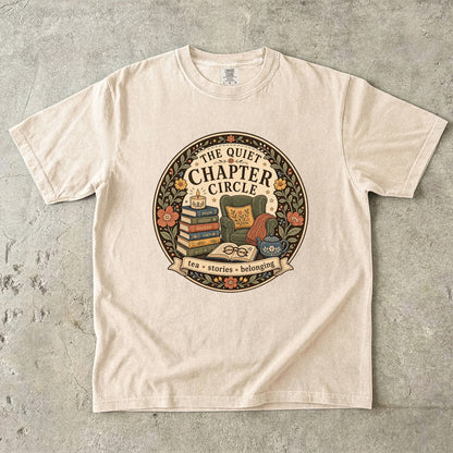 Quiet Chapter Circle book club T-shirt with armchair, stacked books, teapot and floral reading design on Ivory.