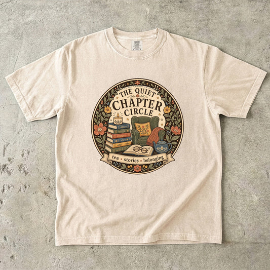 Quiet Chapter Circle book club T-shirt with armchair, stacked books, teapot and floral reading design on Ivory.