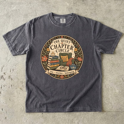 Quiet Chapter Circle book club T-shirt with armchair, stacked books, teapot and floral reading design on Pepper.