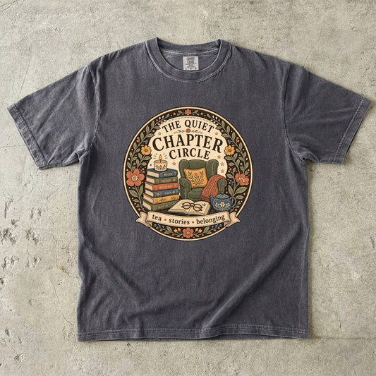 Quiet Chapter Circle book club T-shirt with armchair, stacked books, teapot and floral reading design on Pepper.