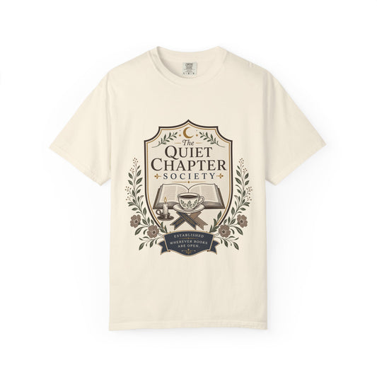 The Quiet Chapter Society book lover T-shirt featuring an open book, teacup, candle and botanical details on Ivory.