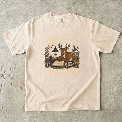 Front view of the Ivory Comfort Colors® Book Lover T-shirt featuring the Quiet Hearts Read Deeply literary woodland illustration.