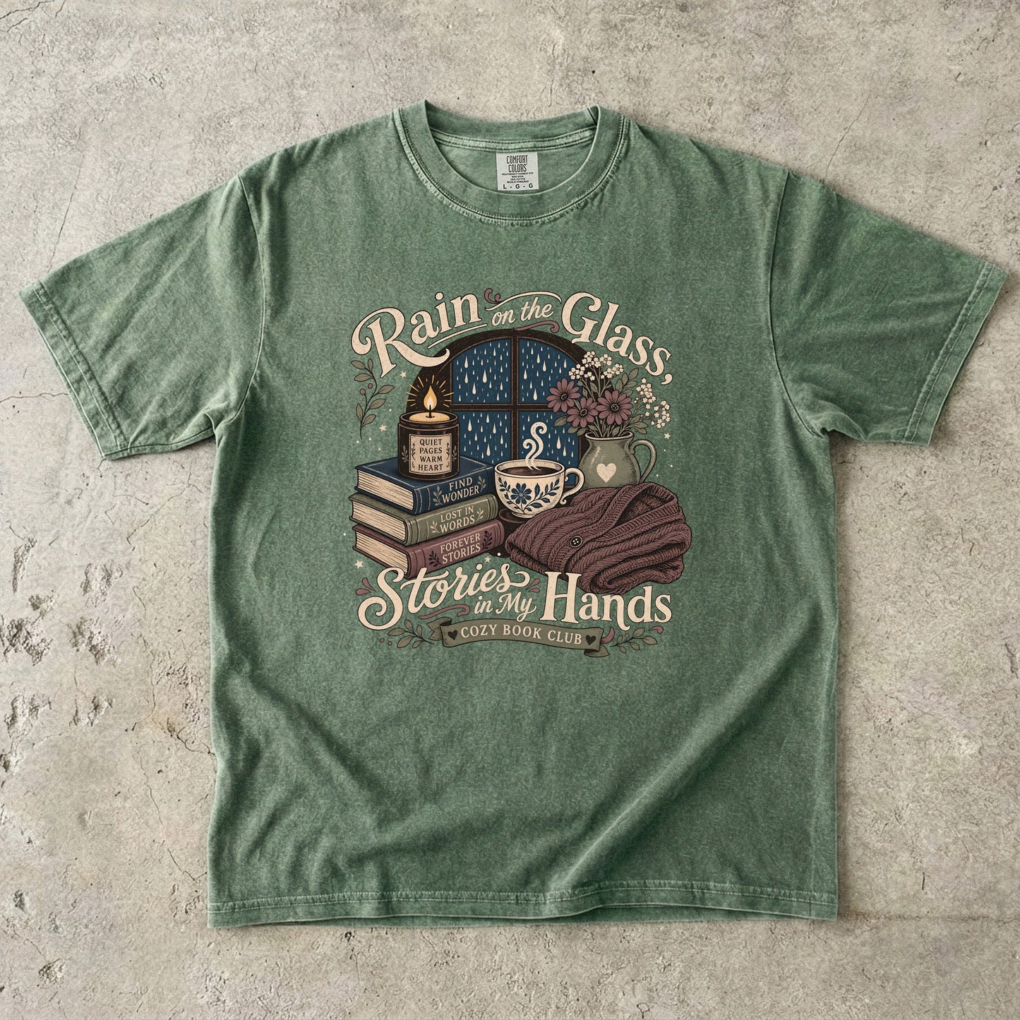 Rain on the Glass rainy day reading T-shirt with books, tea and candle design on Moss.