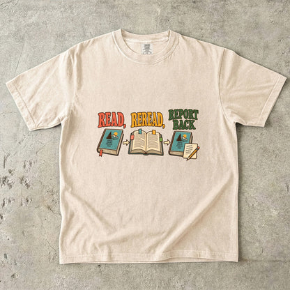 Ivory book club T-shirt with “Read, Reread, Report Back” above three illustrated book moments