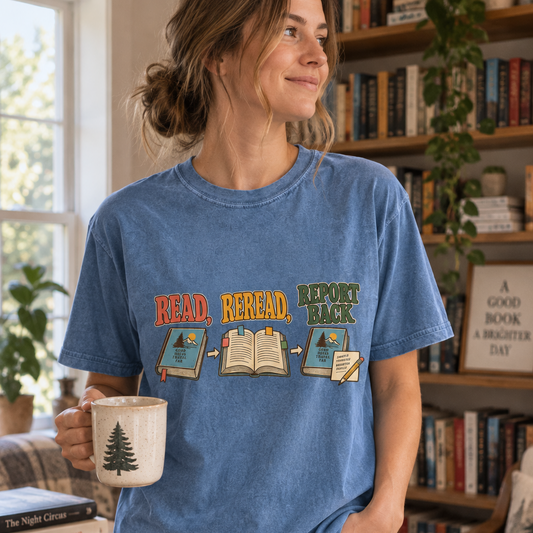 Book club T-shirt featuring “Read, Reread, Report Back” above three illustrated book moments