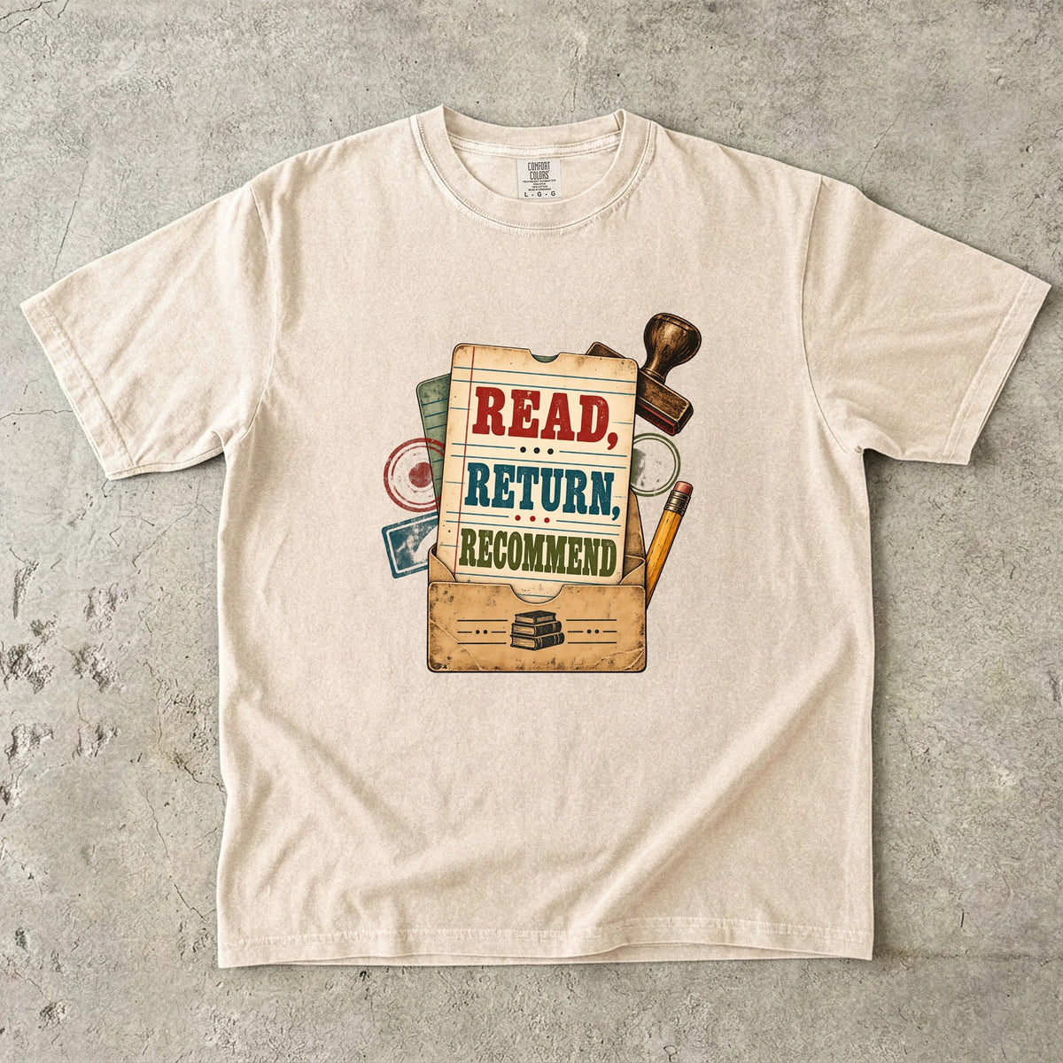 Ivory library lover T-shirt with “Read, Return, Recommend” on a vintage library-style card