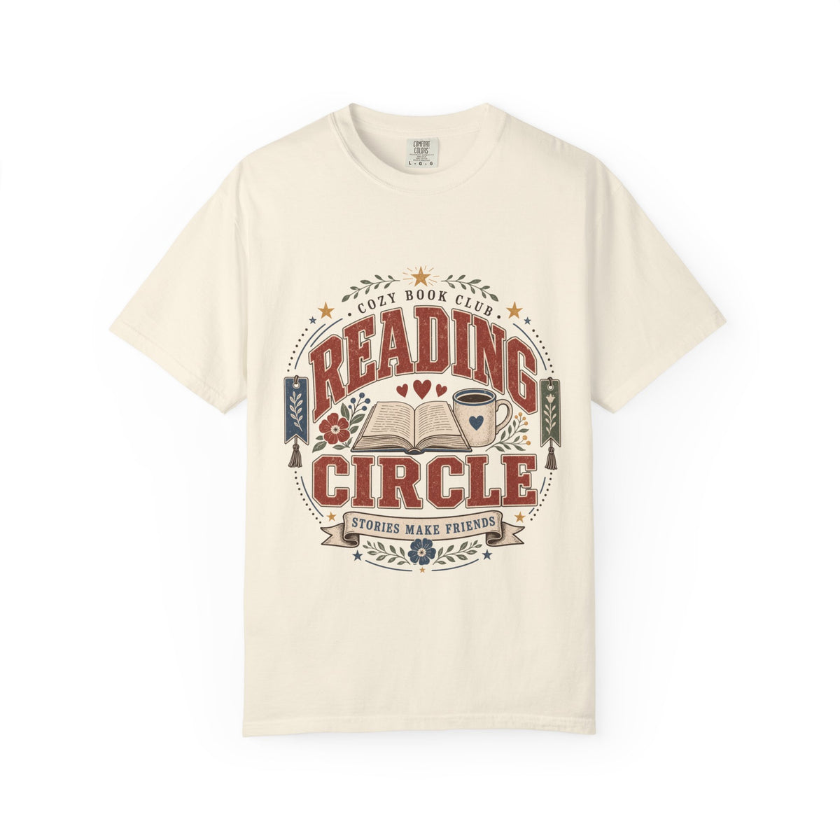 Reading Circle cozy book club T-shirt with open book, coffee mug, floral details, bookmarks and Stories Make Friends design on Ivory.