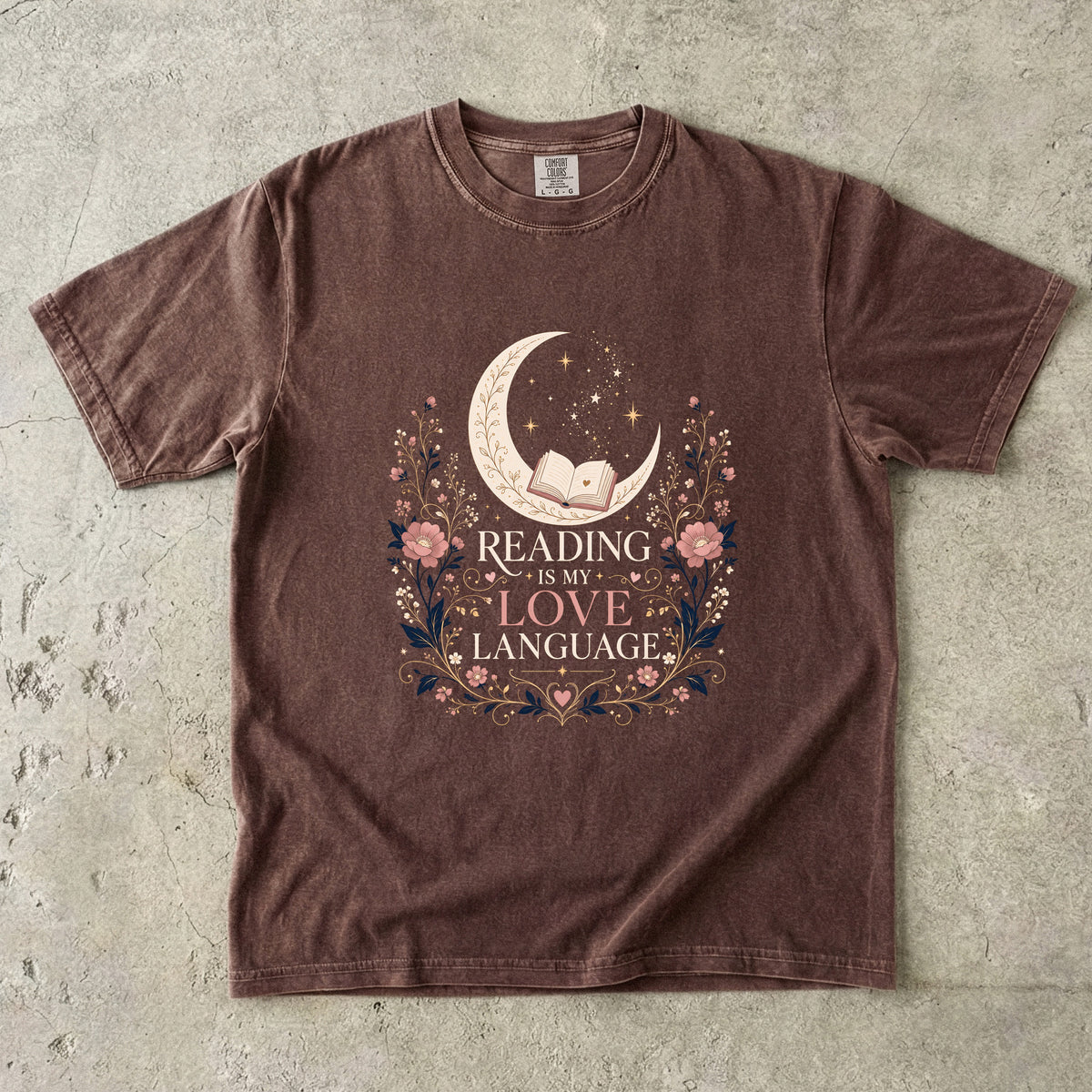 Espresso book lover T-shirt featuring Reading Is My Love Language with an open book, crescent moon, stars and pink floral details.