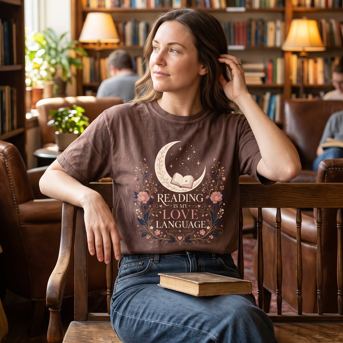 Reading Is My Love Language book lover T-shirt with an open book, crescent moon, stars and pink botanical artwork.