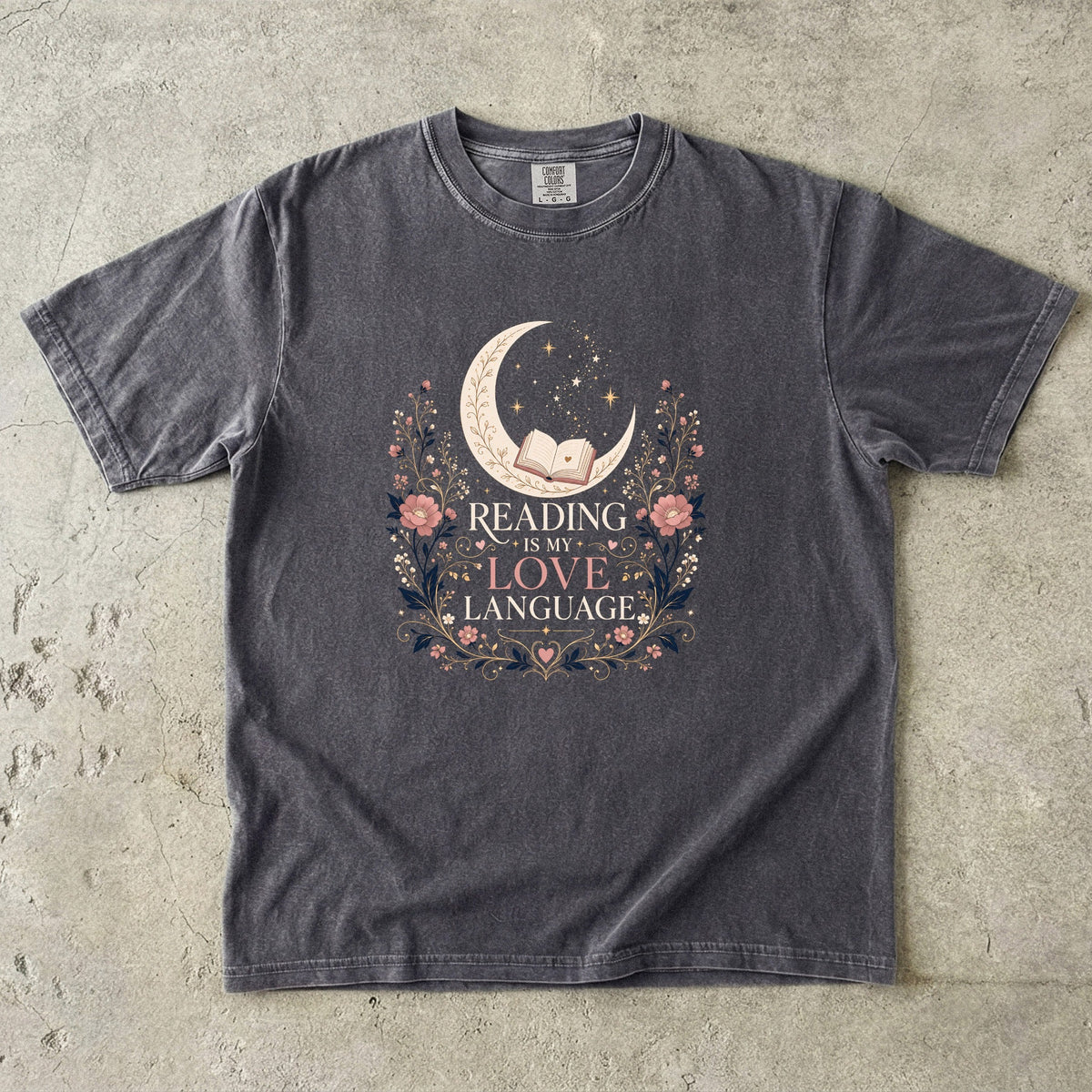 Pepper book lover T-shirt featuring Reading Is My Love Language with an open book, crescent moon, stars and pink floral details.