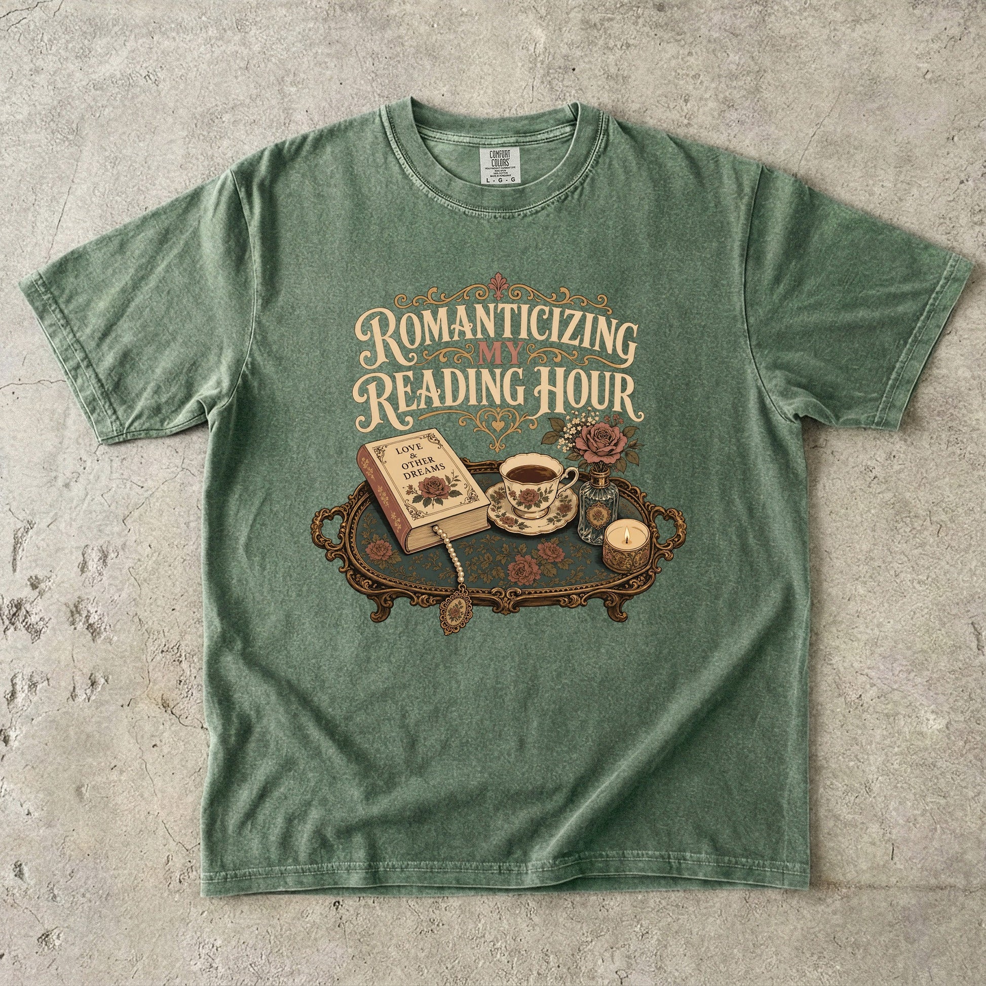 Front view of a Moss Comfort Colors® book lover T-shirt featuring the Romanticizing My Reading Hour design with vintage books, tea, roses, candlelight and cozy reading details.
