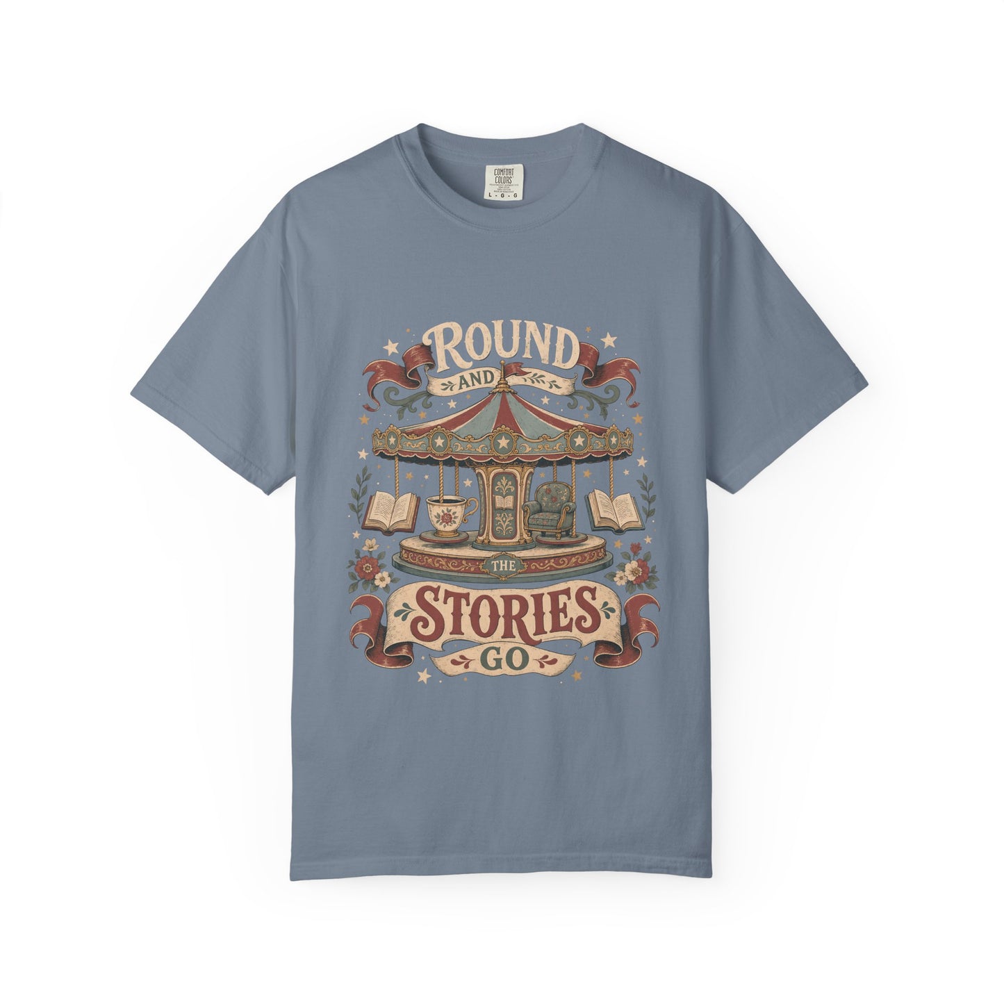 Front view of a Blue Jean Comfort Colors® book lover T-shirt featuring the "Round and Round the Stories Go" vintage carousel, books, teacup and reading chair illustration.
