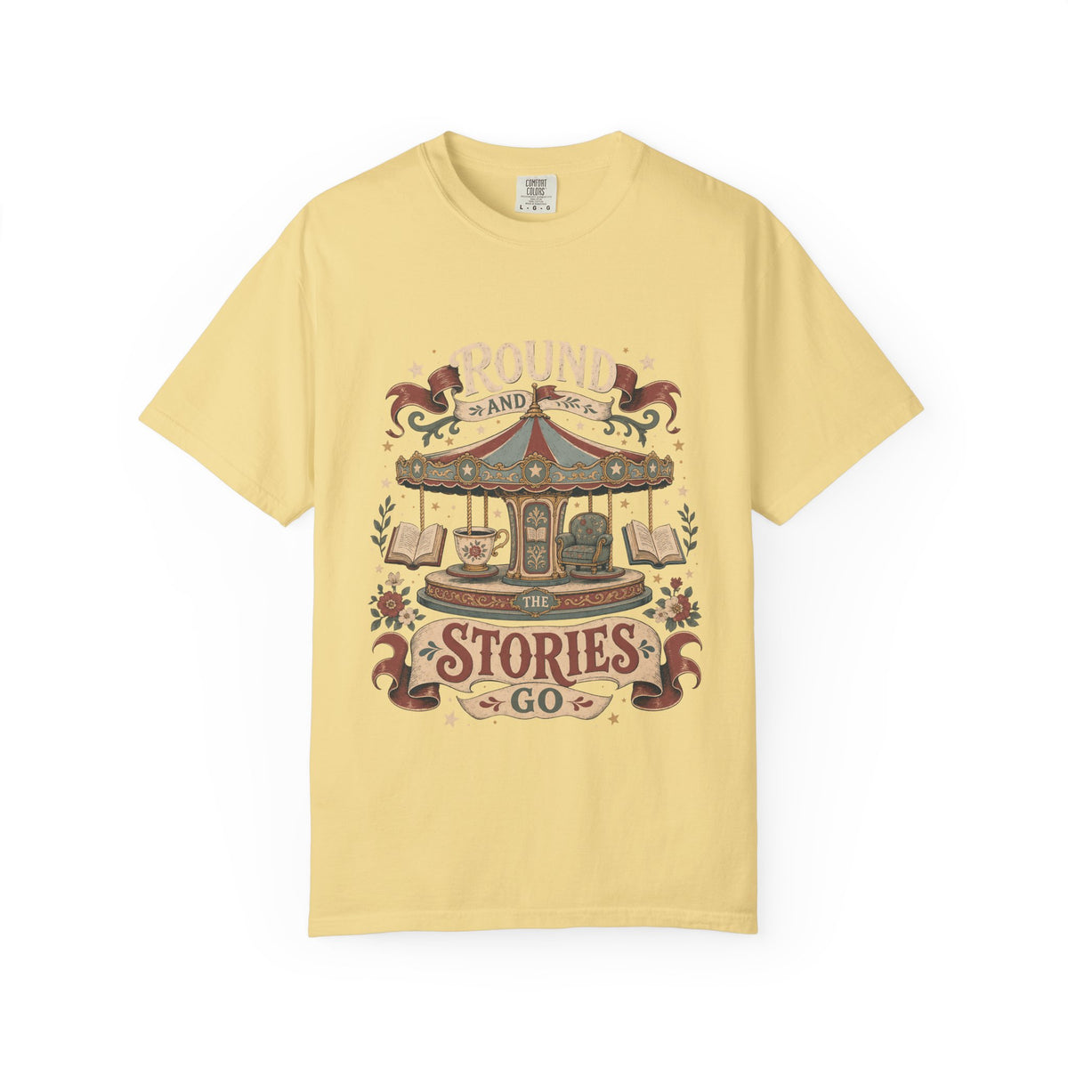 Round and Round the Stories Go book lover T-shirt in Butter featuring a vintage carousel with open books, reading chair and teacup