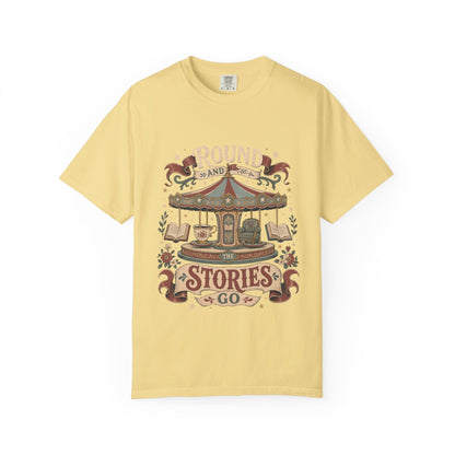 Round and Round the Stories Go book lover T-shirt in Butter featuring a vintage carousel with open books, reading chair and teacup