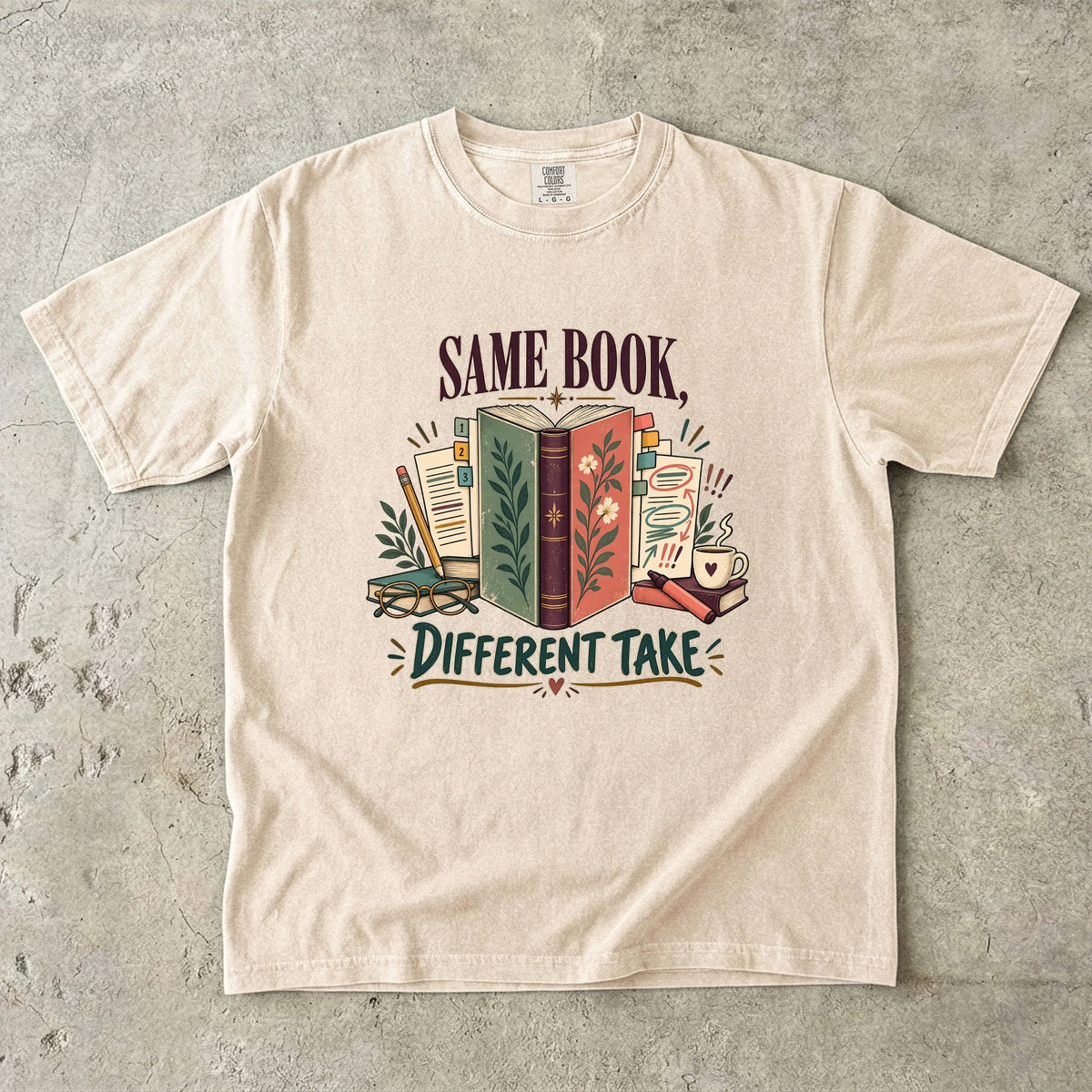 Ivory book club T-shirt with “Same Book, Different Take,” an open book and annotated pages