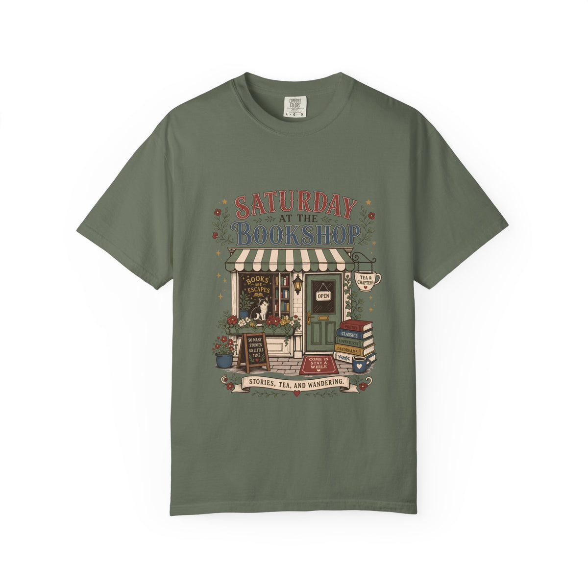 Saturday at the Bookshop book lover T-shirt featuring a cozy bookstore, stacked books, flowers, cat and tea details on Moss.
