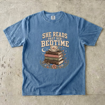 Blue Jean reading T-shirt featuring She Reads Past Her Bedtime with stacked books, a floral teacup, flowers and crescent moon.