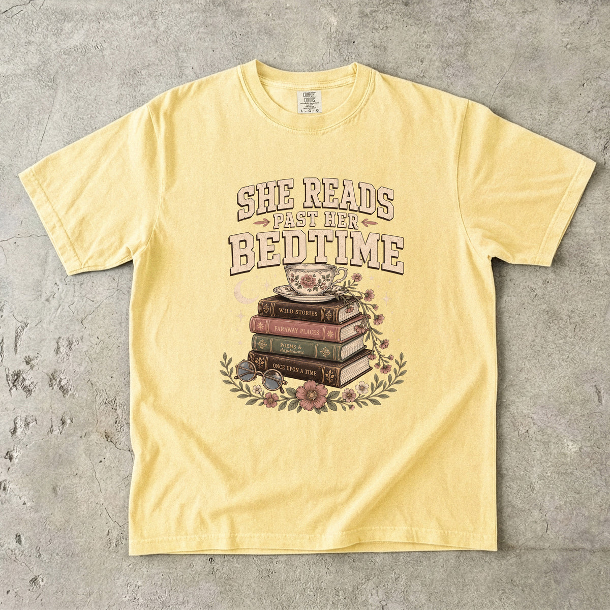 Butter reading T-shirt featuring She Reads Past Her Bedtime with stacked books, a floral teacup, flowers and crescent moon.