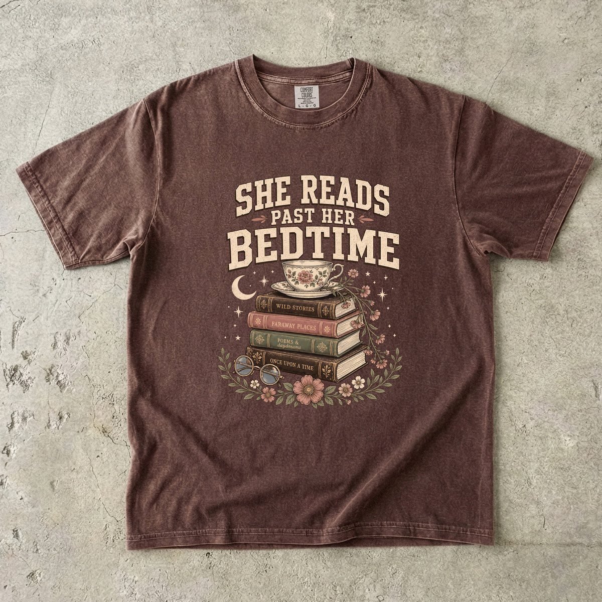 Espresso reading T-shirt featuring She Reads Past Her Bedtime with stacked books, a floral teacup, flowers and crescent moon.