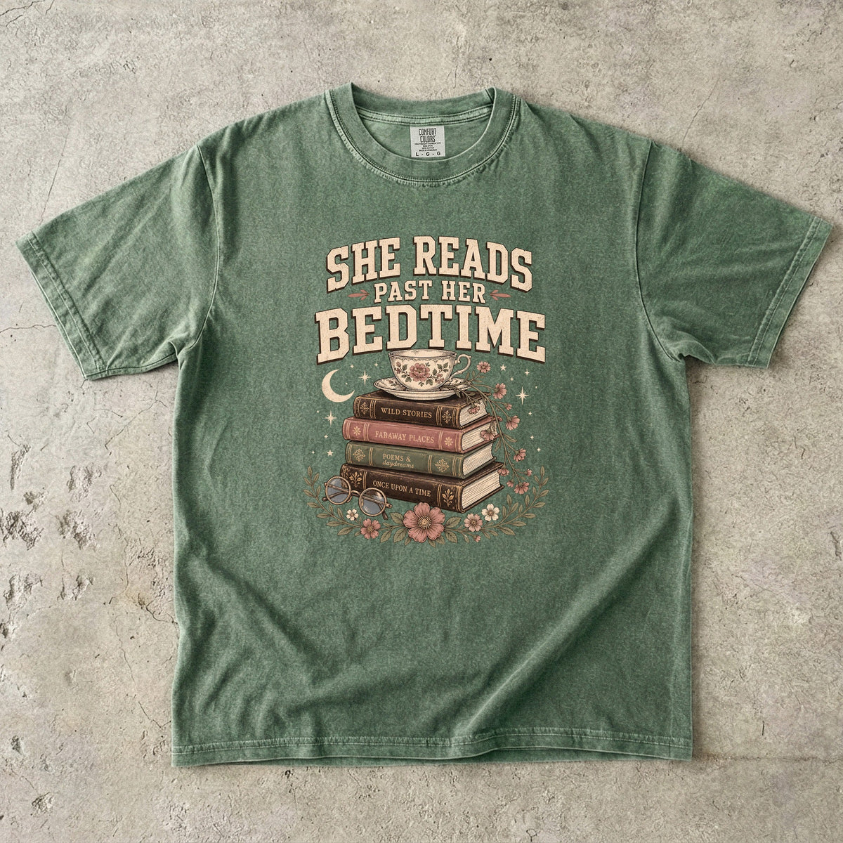 Moss reading T-shirt featuring She Reads Past Her Bedtime with stacked books, a floral teacup, flowers and crescent moon.