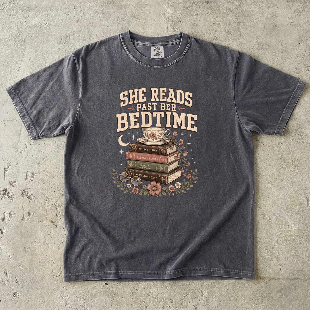 Pepper reading T-shirt featuring She Reads Past Her Bedtime with stacked books, a floral teacup, flowers and crescent moon.