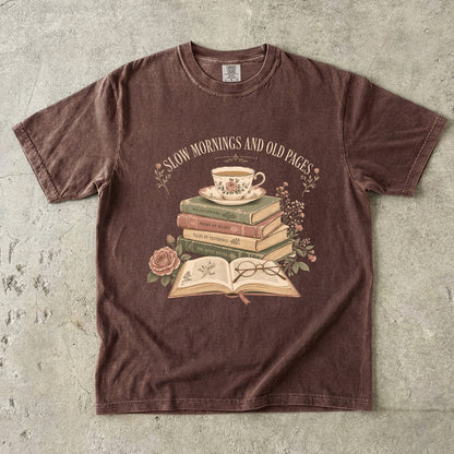 Espresso reading T-shirt featuring Slow Mornings and Old Pages with stacked vintage books, a floral teacup, open book, glasses and roses.