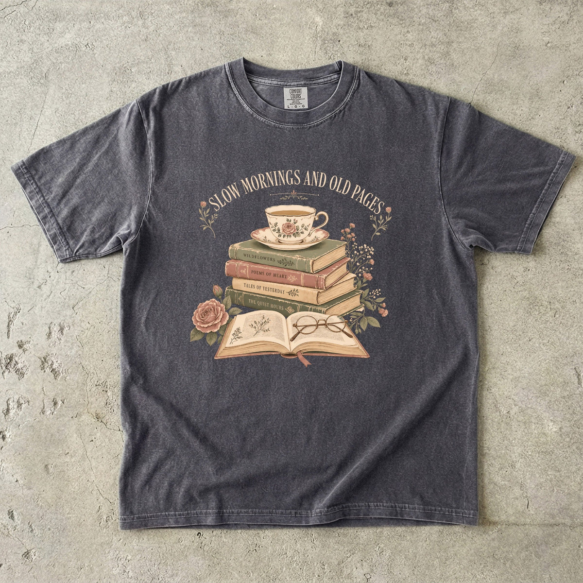 Pepper reading T-shirt featuring Slow Mornings and Old Pages with stacked vintage books, a floral teacup, open book, glasses and roses.