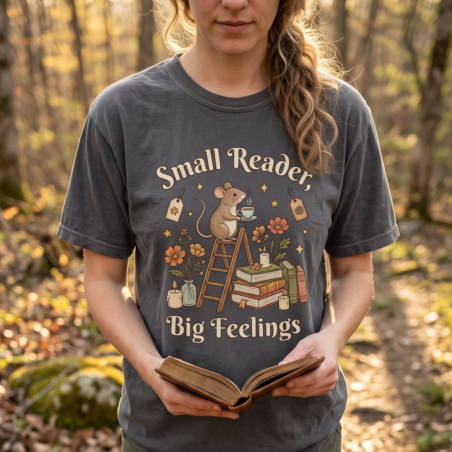 Small Reader, Big Feelings book lover T-shirt featuring a whimsical mouse reader surrounded by books and flowers