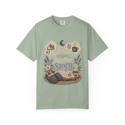 Soft Steps Into Another Story book lover shirt on a Comfort Colors bay T-shirt featuring vintage-inspired artwork with books, cosy slippers, flowers and coffee mugs.

