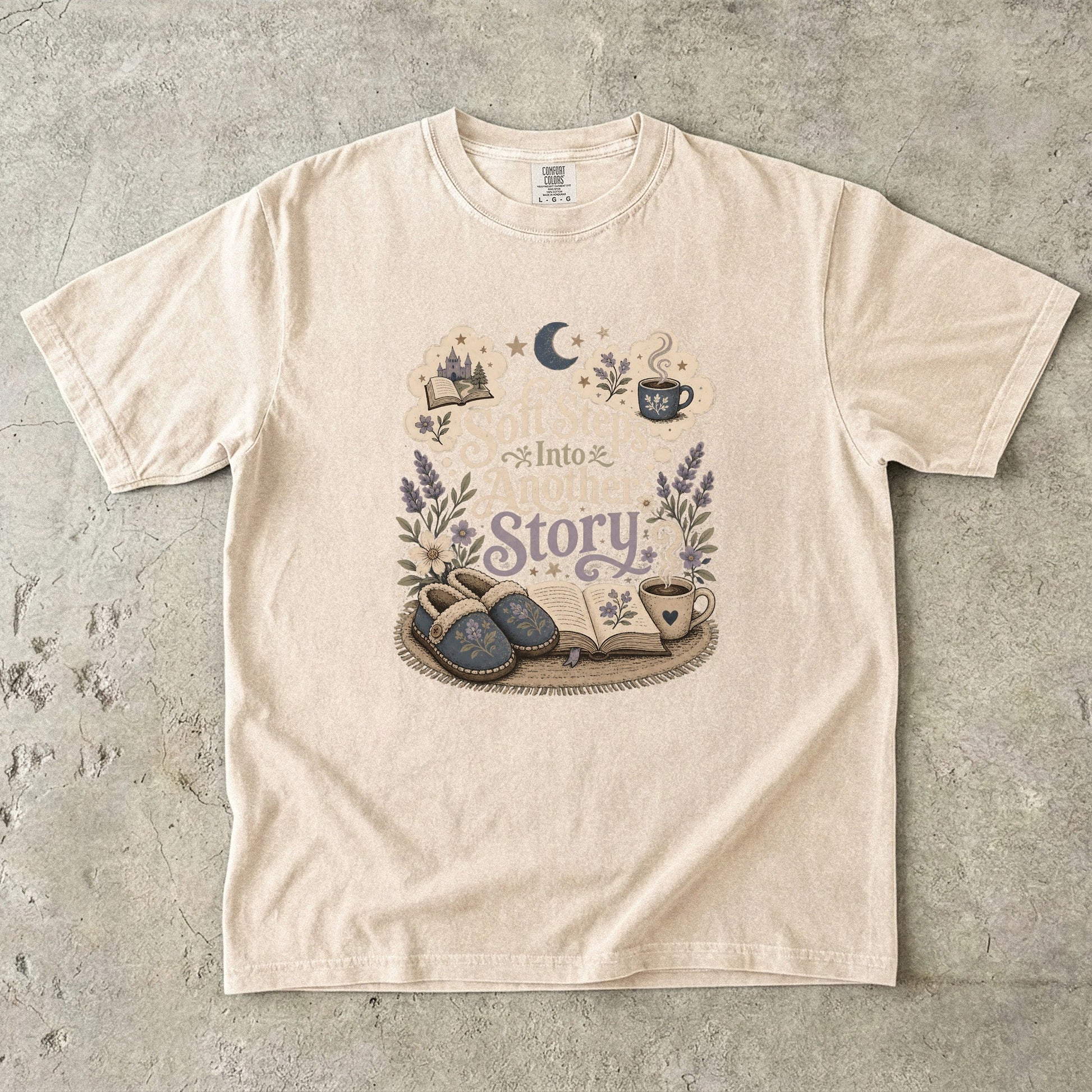 Soft Steps Into Another Story cozy reading T-shirt in Ivory featuring slippers, an open book, flowers and a warm drink
