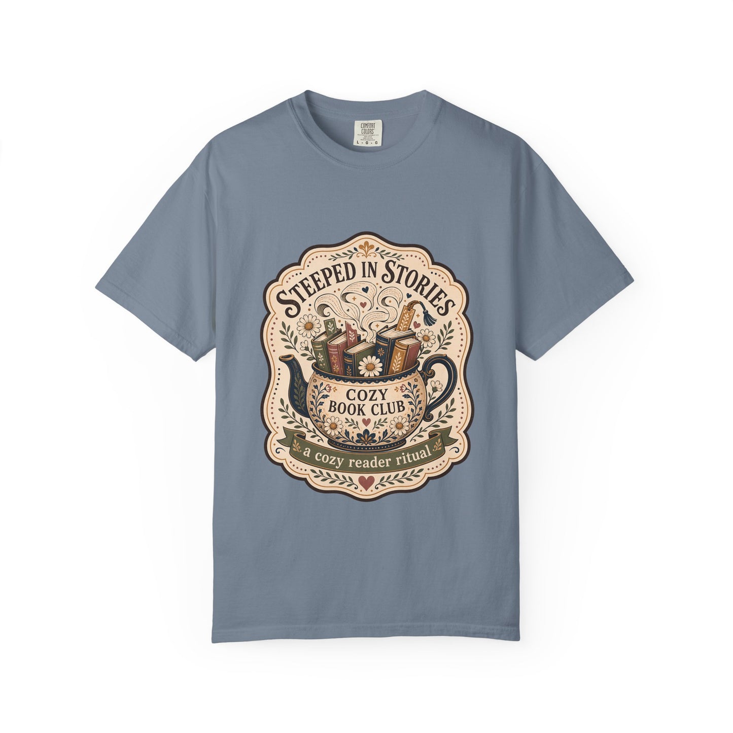 Steeped in Stories book lover T-shirt with a floral teapot overflowing with books on Blue Jean.