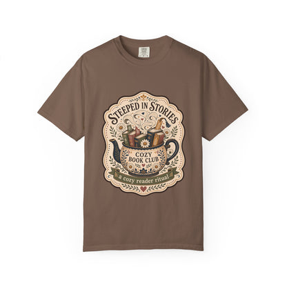 Steeped in Stories book lover T-shirt with a floral teapot overflowing with books on Espresso.