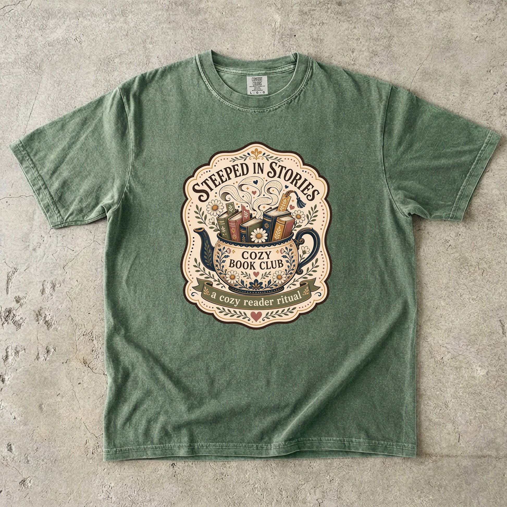 Steeped in Stories book lover T-shirt with a floral teapot overflowing with books on Moss.