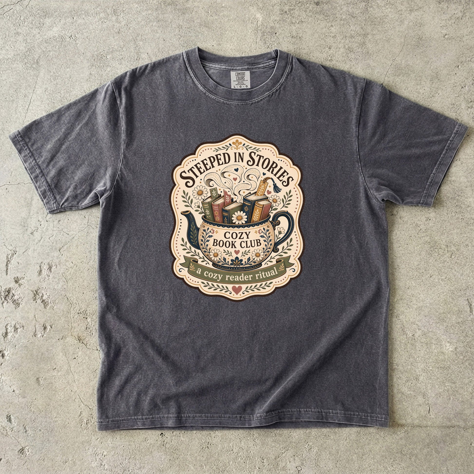 Steeped in Stories book lover T-shirt with a floral teapot overflowing with books on Pepper.