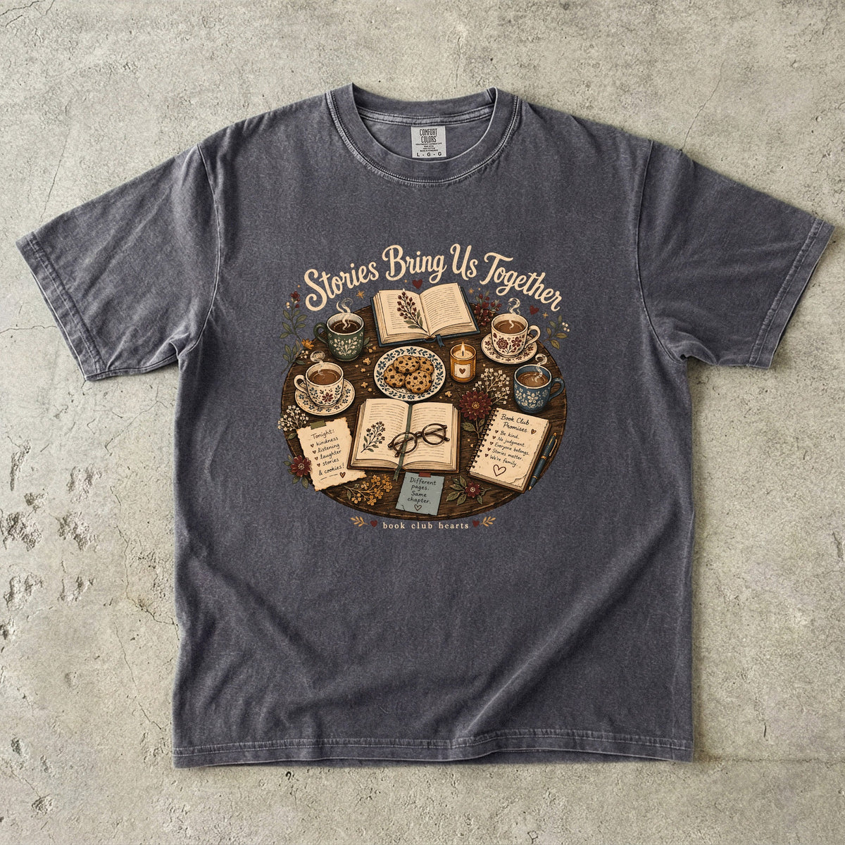 Stories Bring Us Together book club T-shirt featuring open books, tea, cookies and flowers on Pepper.