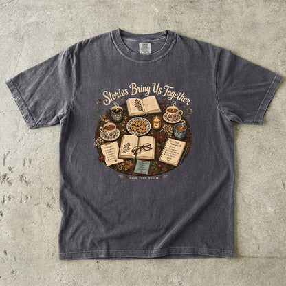 Stories Bring Us Together book club T-shirt featuring open books, tea, cookies and flowers on Pepper.