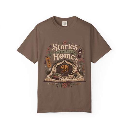 Stories Feel Like Home book lover T-shirt with open book, cozy reading nook, stacked books, teacup and floral details on Espresso.
