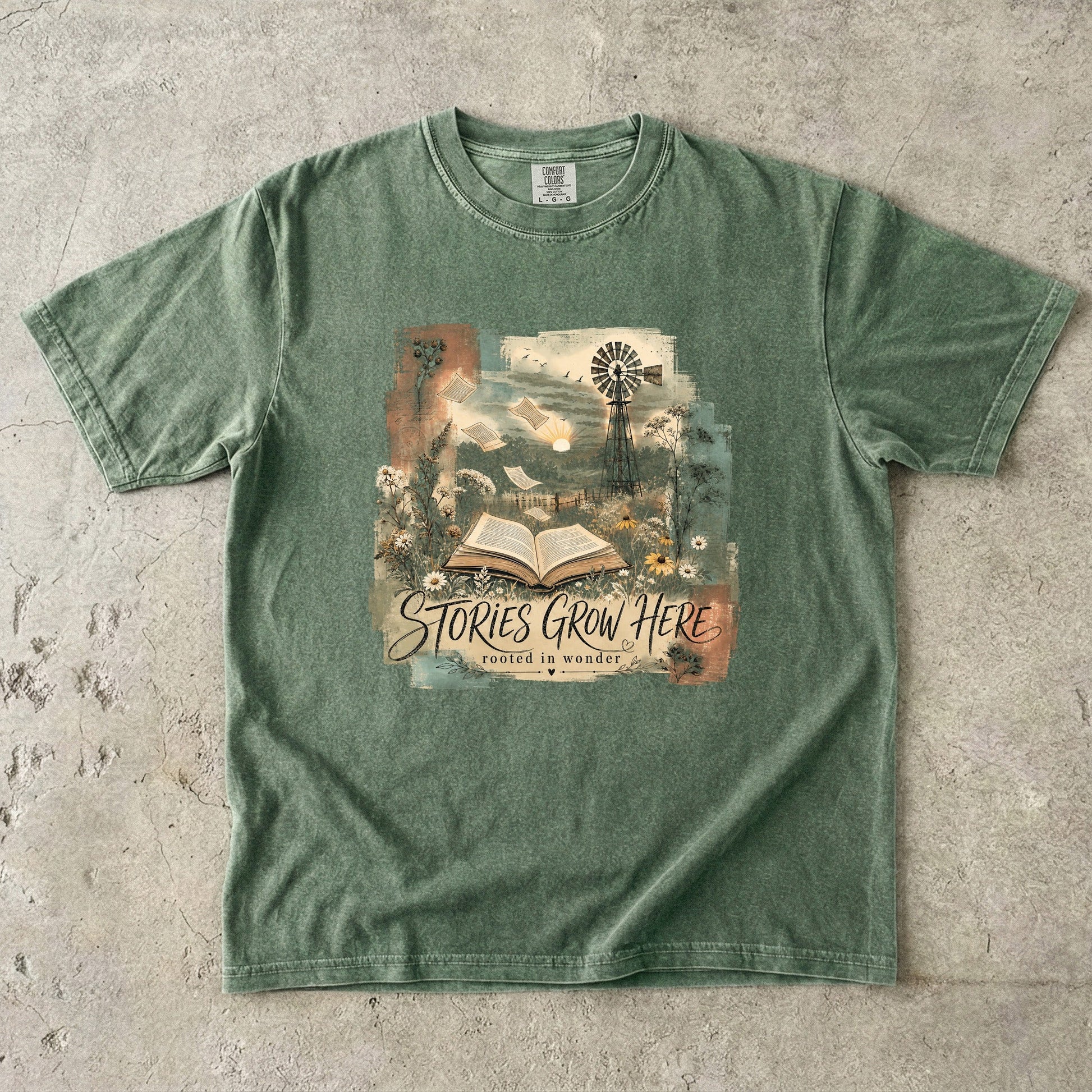 Moss Comfort Colors Stories Grow Here book lover T-shirt featuring a vintage open book and nature illustration.